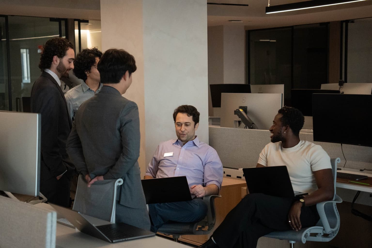 The STLabs team gathered around a desk in the office